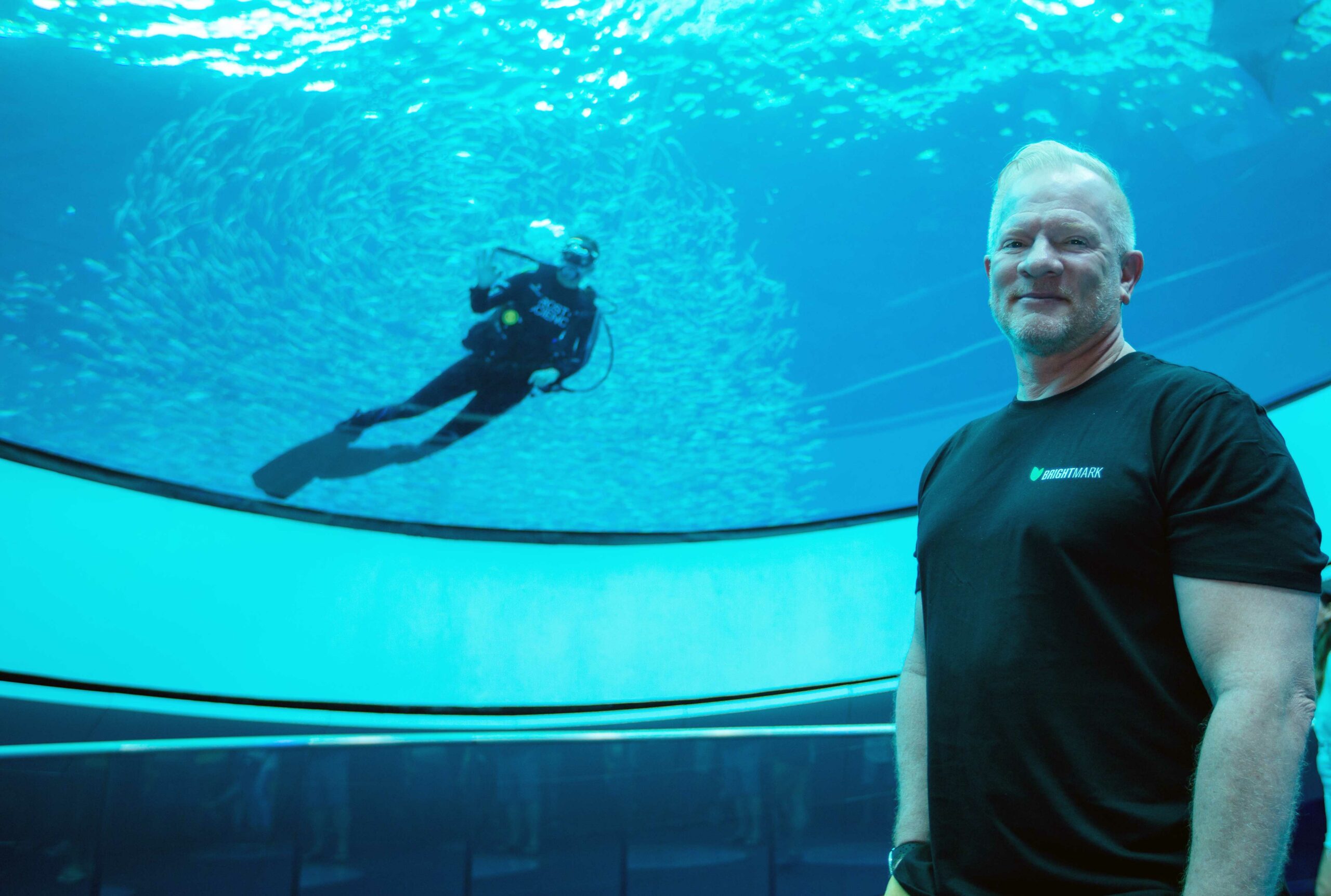 CEO Bob Powell in aquarium with scuba diver