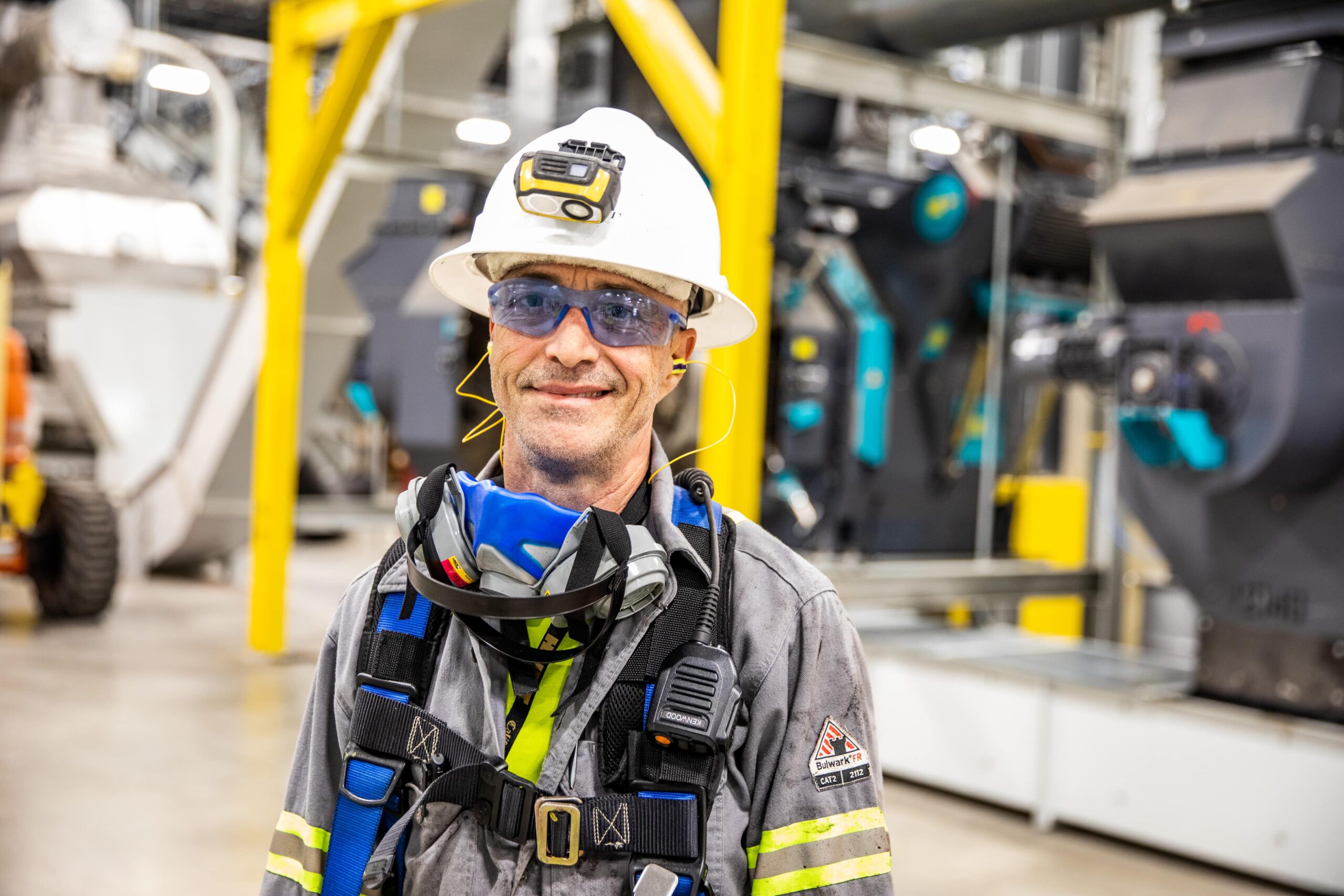 Portrait of a man wearing a hard hat and safety vest.