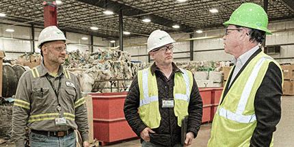 Group of men in a recycling facility