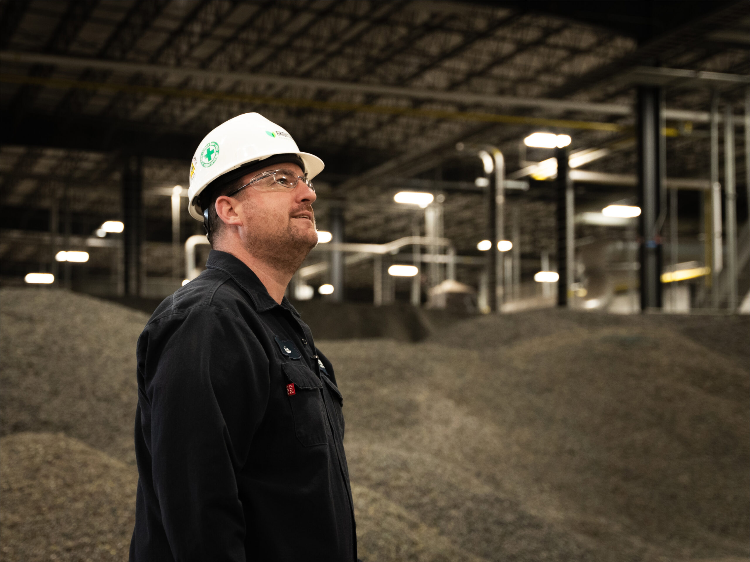 Man wearing hard hat inside of a plastics renewal facility