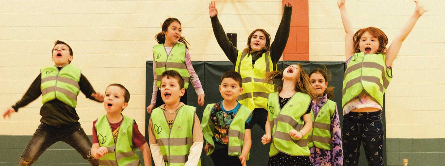 Kids in vests jumping in the air